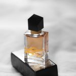 Elegant perfume bottle with black cap on a stylish box in Paris.