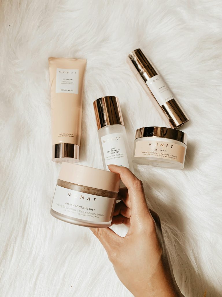 Collection of luxury skincare products arranged on a warm, soft fur surface for a chic presentation.